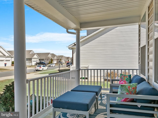 wooden deck with covered porch and a residential view