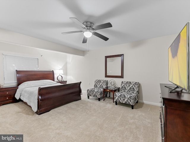 bedroom with light carpet, a ceiling fan, and baseboards