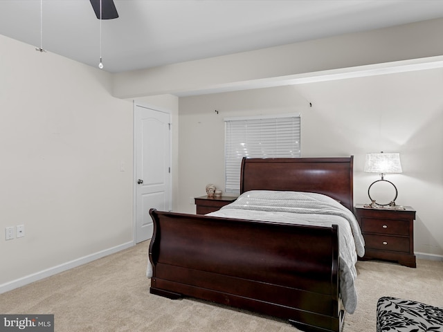 carpeted bedroom with baseboards and a ceiling fan