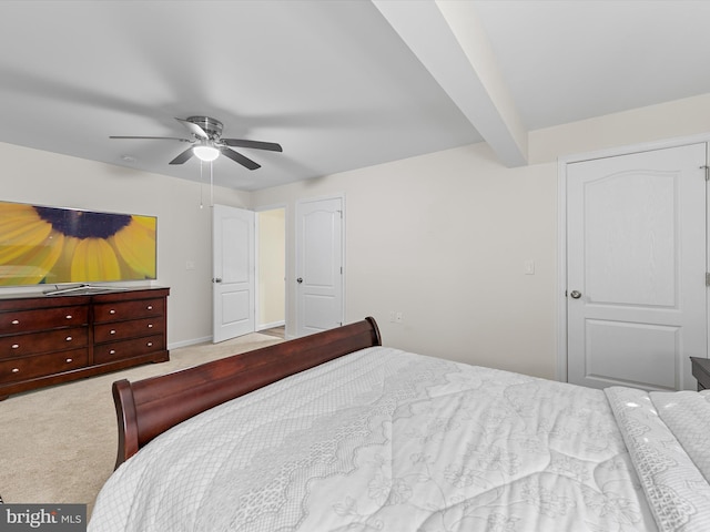 carpeted bedroom with beam ceiling and ceiling fan