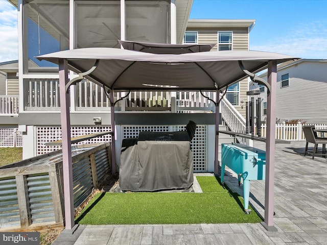 view of patio / terrace featuring stairs and fence