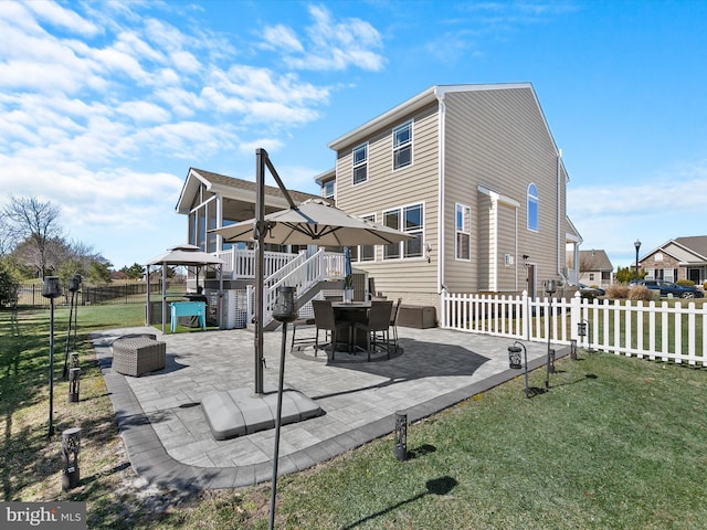 back of property with a patio, a lawn, and fence private yard