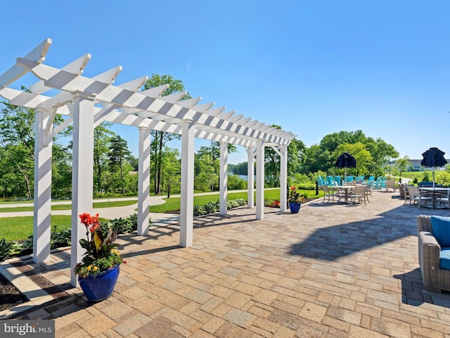 view of patio featuring outdoor dining space and a pergola