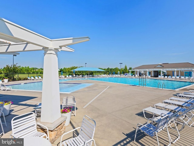 community pool featuring a patio and fence