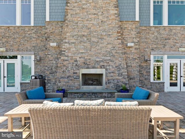 view of patio / terrace with french doors and an outdoor living space with a fireplace