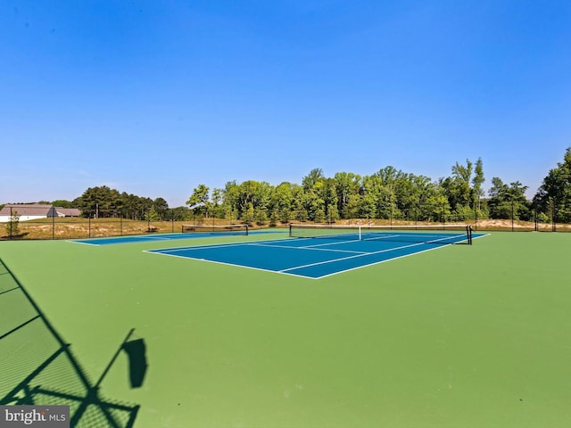 view of sport court featuring fence