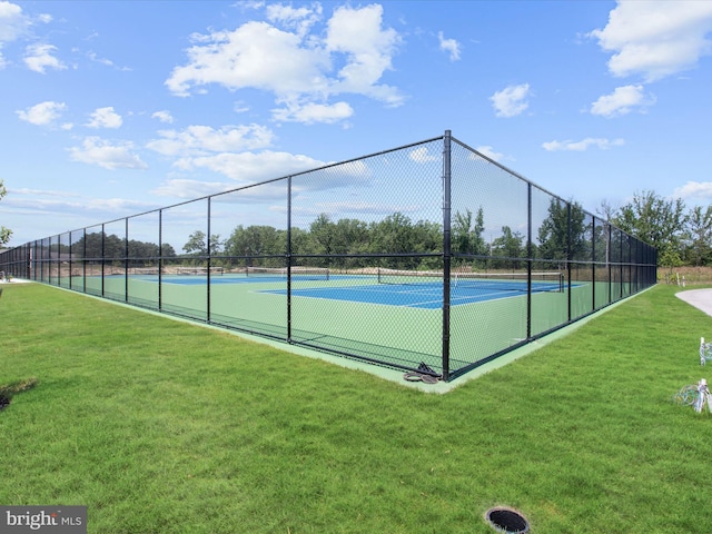 view of sport court featuring a yard and fence