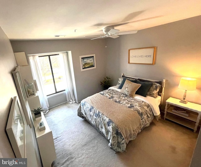 bedroom featuring visible vents, carpet, and a ceiling fan