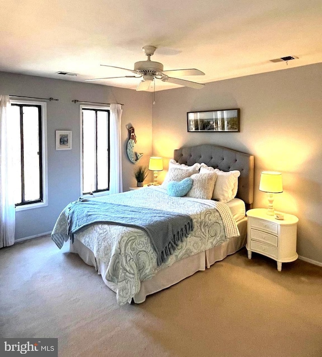 bedroom with carpet, visible vents, and ceiling fan