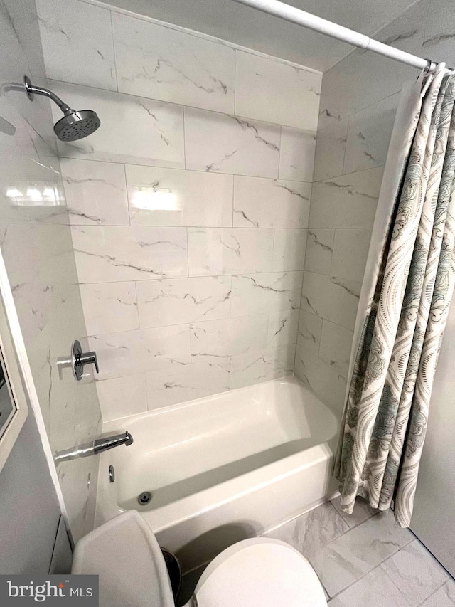 bathroom featuring shower / tub combo with curtain and marble finish floor