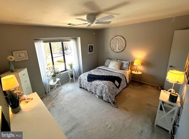 bedroom featuring a ceiling fan, visible vents, carpet floors, and baseboards