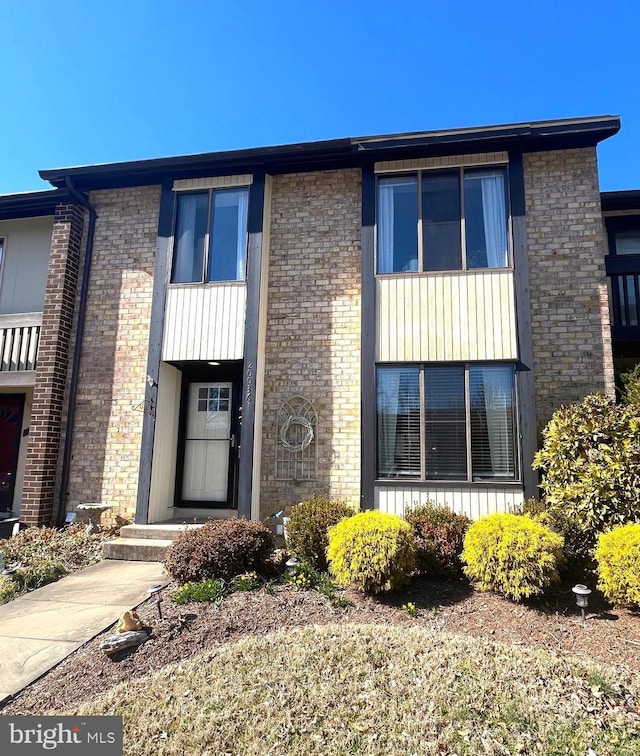 townhome / multi-family property with brick siding