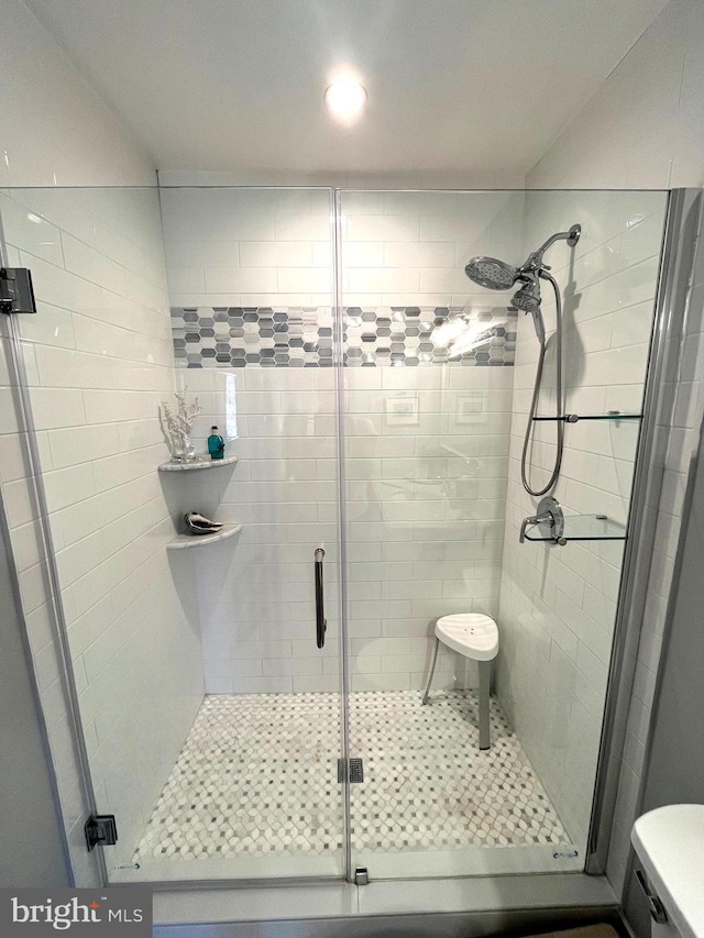 full bath with a shower stall and toilet