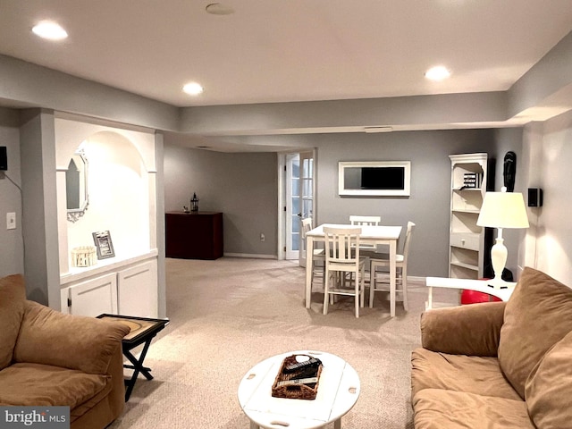 living area featuring recessed lighting, light colored carpet, and baseboards