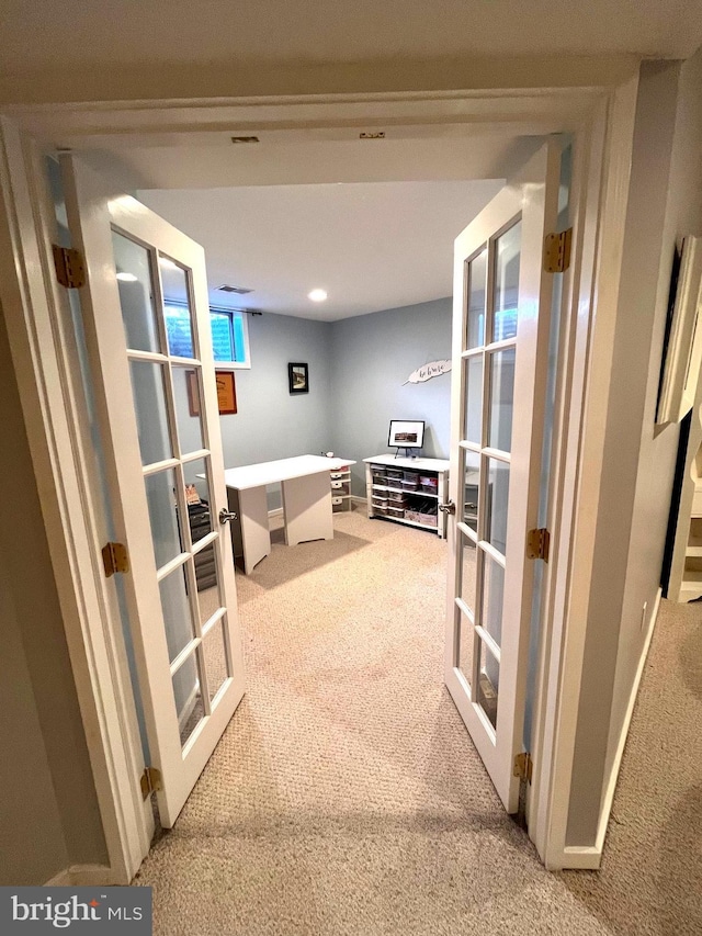 corridor with french doors, baseboards, and carpet floors