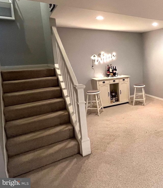 staircase featuring carpet flooring, recessed lighting, and baseboards