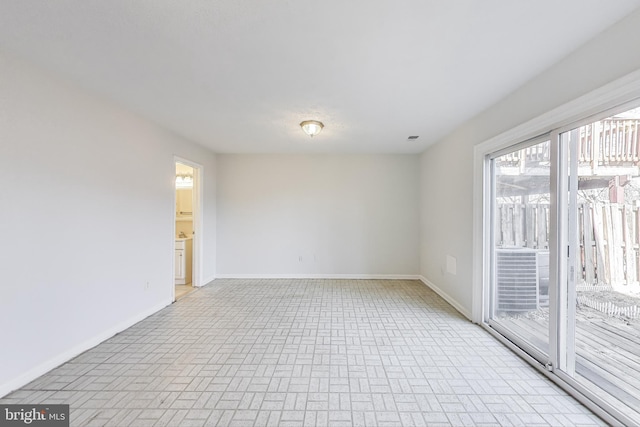 spare room featuring baseboards