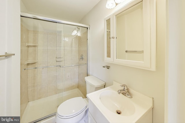 bathroom featuring vanity, toilet, a stall shower, and baseboard heating