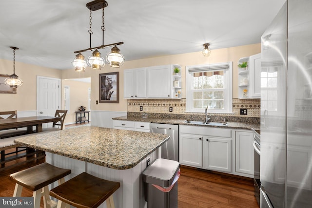 kitchen featuring a sink, open shelves, decorative backsplash, appliances with stainless steel finishes, and dark wood-style flooring