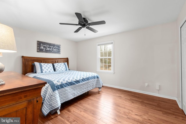 bedroom with ceiling fan, light wood-type flooring, and baseboards