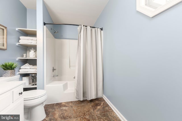 bathroom featuring stone finish flooring, baseboards, toilet, shower / bath combination with curtain, and vanity