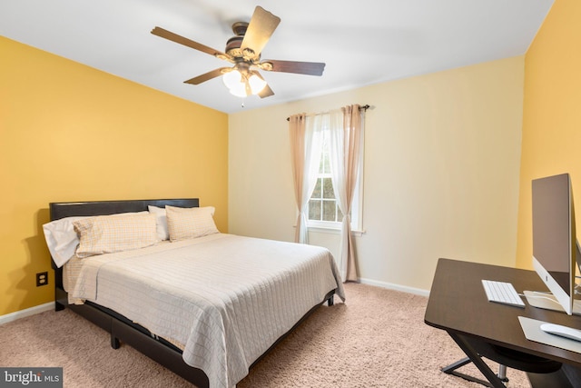 carpeted bedroom with a ceiling fan and baseboards