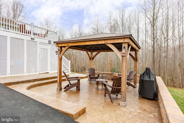 view of patio / terrace featuring a gazebo, an outdoor fire pit, and stairs