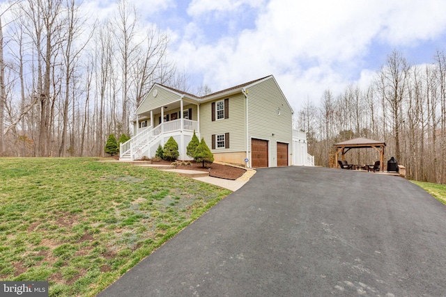 view of front of house featuring aphalt driveway, a gazebo, stairway, a front yard, and an attached garage