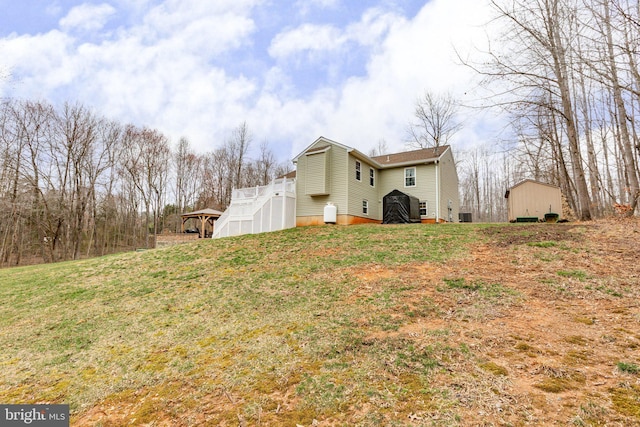 view of home's exterior with a deck and a yard