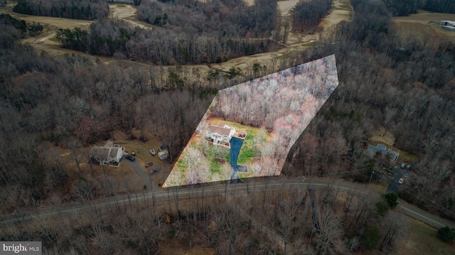 birds eye view of property with a forest view