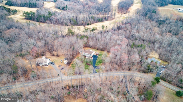 birds eye view of property with a forest view