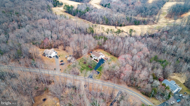 birds eye view of property featuring a view of trees