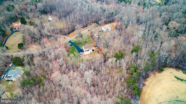 birds eye view of property with a wooded view