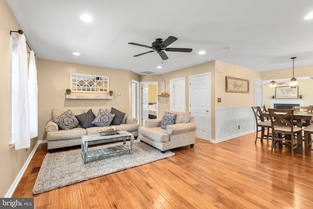 living room featuring visible vents, recessed lighting, a ceiling fan, and wood finished floors