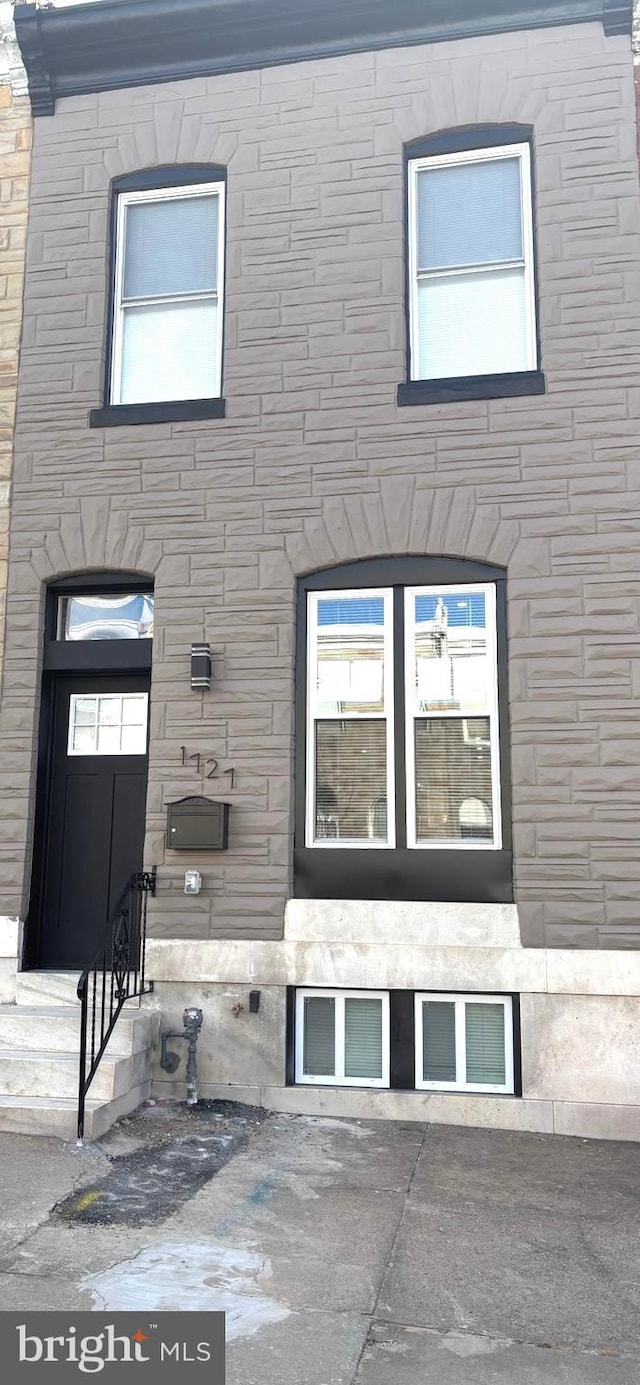 exterior space featuring stone siding