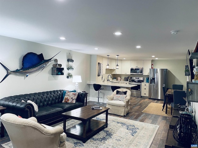 living area with recessed lighting and dark wood-style flooring