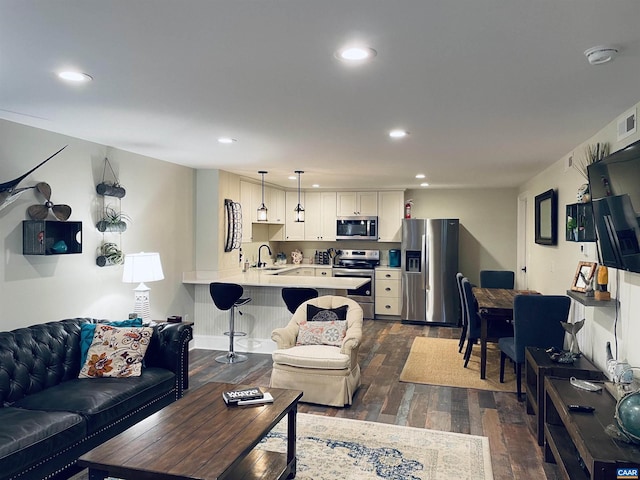 living room featuring recessed lighting, visible vents, and dark wood-style flooring