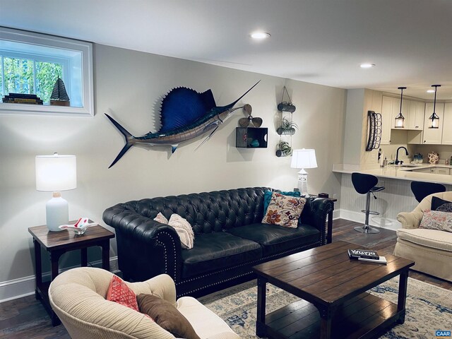 living area featuring recessed lighting, baseboards, and dark wood finished floors