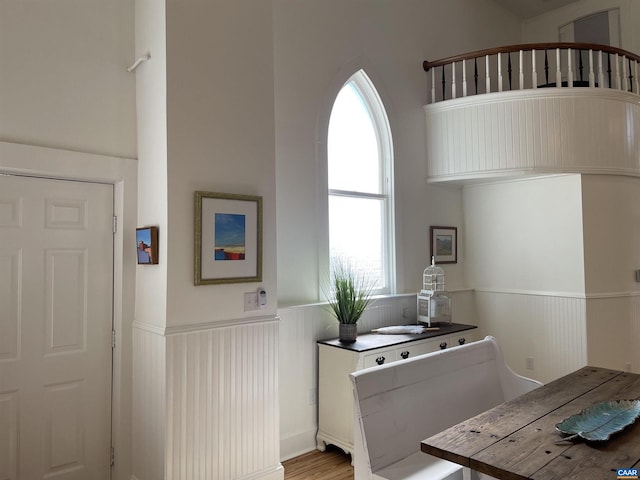 bathroom featuring wood finished floors and a wainscoted wall