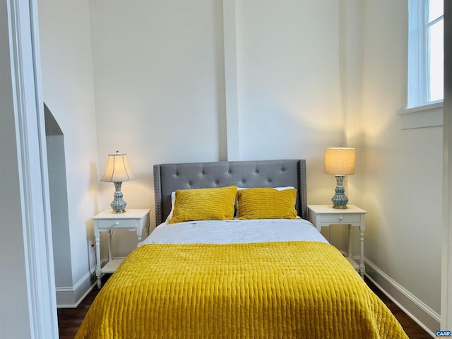 bedroom featuring dark wood-type flooring and baseboards