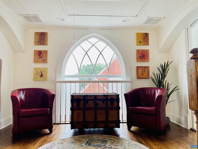 sitting room featuring attic access, hardwood / wood-style flooring, and visible vents