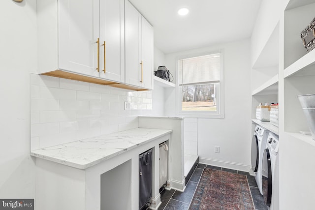 laundry room with recessed lighting, washer and dryer, and baseboards