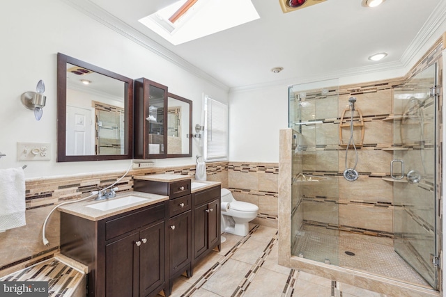 bathroom with toilet, a stall shower, ornamental molding, tile walls, and a skylight