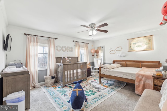 bedroom featuring carpet floors, ceiling fan, and crown molding