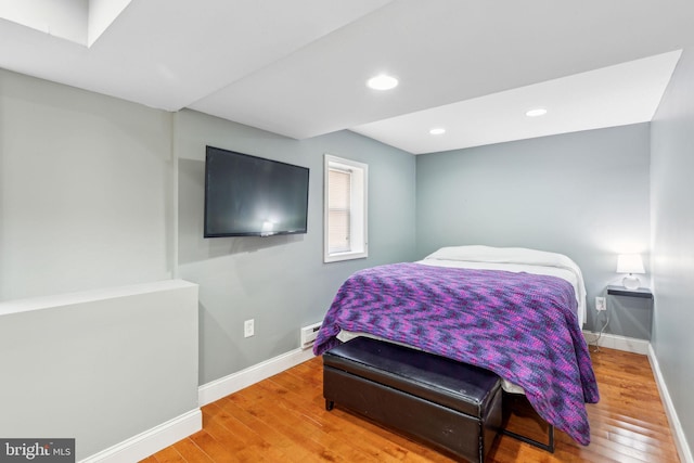 bedroom with recessed lighting, baseboards, and wood finished floors