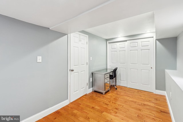 bonus room with light wood-style floors and baseboards