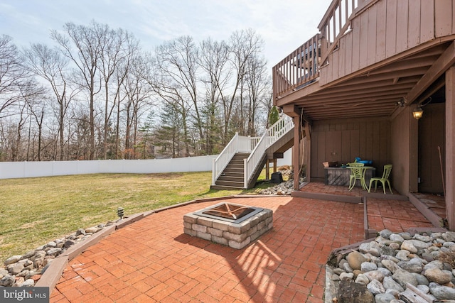 view of patio featuring stairs, a fire pit, and fence