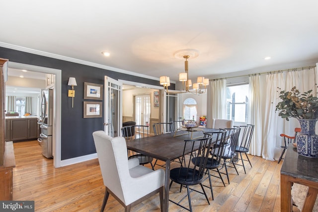 dining area with baseboards, ornamental molding, recessed lighting, light wood-style floors, and a notable chandelier