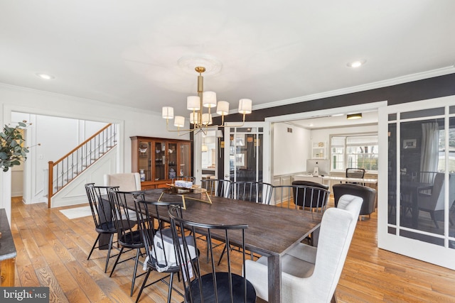 dining room featuring stairway, recessed lighting, crown molding, a notable chandelier, and light wood-type flooring