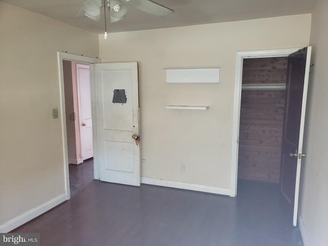 unfurnished bedroom with baseboards and wood finished floors